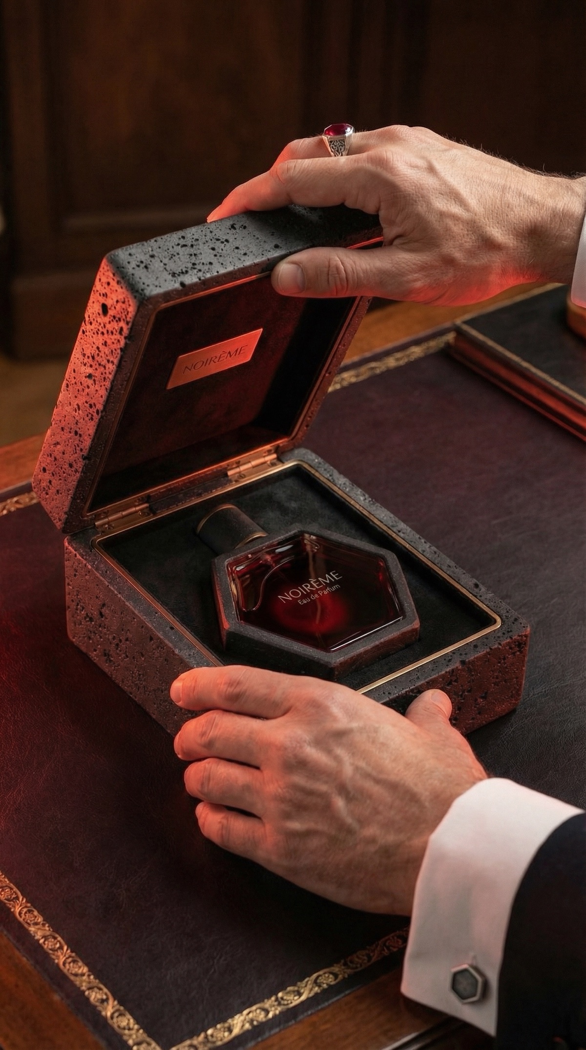 Noir&egrave;me — hands opening the volcanic basalt presentation case
